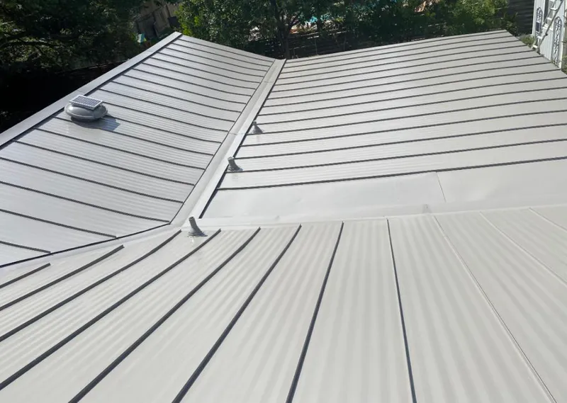 Solar attic fan installed on a metal roof for Roof Ventilation in Carnegie